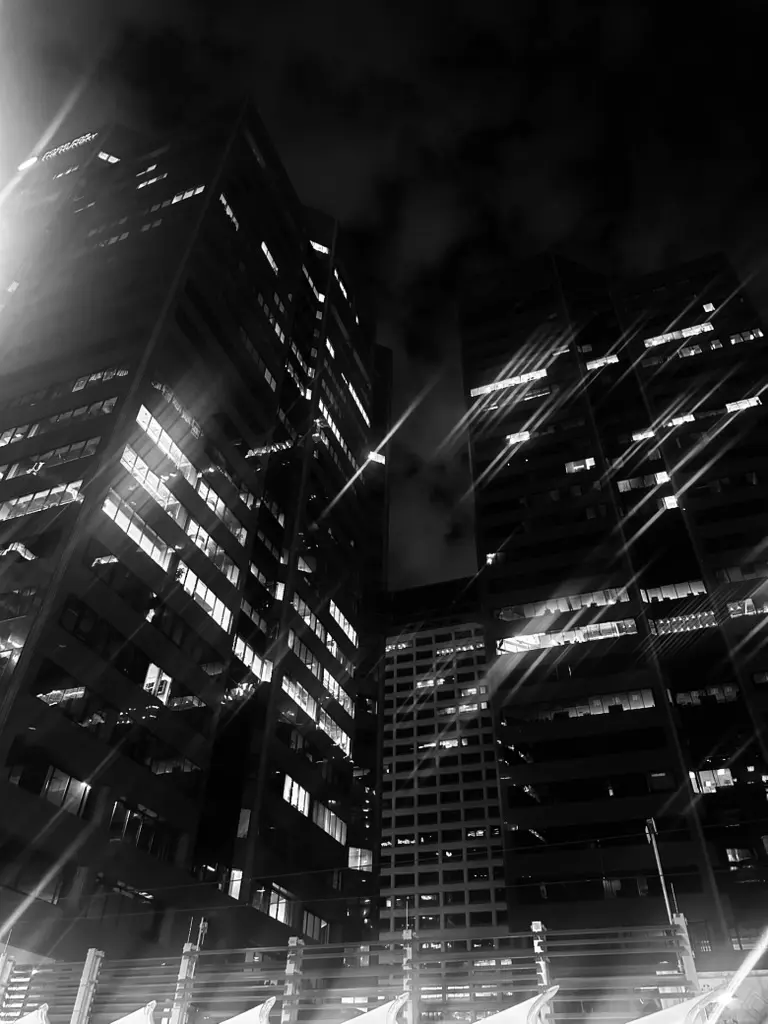 Downtown Phoenix office towers at night, lit windows against a dark sky
